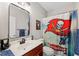 Bathroom with vanity, toilet and Tampa Bay Buccaneers themed shower curtain at 15927 Ternglade Dr, Lithia, FL 33547