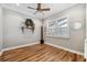 Bright bedroom with wood-look floors and plantation shutters at 15927 Ternglade Dr, Lithia, FL 33547