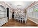 Formal dining room with floral wallpaper, a large table, and a chandelier at 15927 Ternglade Dr, Lithia, FL 33547