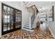 Bright entryway with herringbone floor, staircase, and French doors at 15927 Ternglade Dr, Lithia, FL 33547