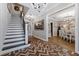 Elegant entryway with herringbone flooring, a grand staircase, and views to dining room at 15927 Ternglade Dr, Lithia, FL 33547