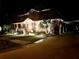 Two-story home exterior with lights illuminating the home at night at 15927 Ternglade Dr, Lithia, FL 33547