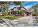 Two-story home with a wraparound porch and paver driveway at 15927 Ternglade Dr, Lithia, FL 33547