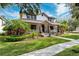 Two-story home with a wraparound porch and landscaping at 15927 Ternglade Dr, Lithia, FL 33547