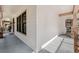 Inviting front porch with gray decking, stone pillars, and charming window details at 15927 Ternglade Dr, Lithia, FL 33547