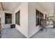 A welcoming front porch with gray wood decking and wicker chair at 15927 Ternglade Dr, Lithia, FL 33547