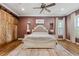 Main bedroom with rustic barn doors and a cozy sitting area at 15927 Ternglade Dr, Lithia, FL 33547