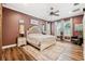 Large main bedroom with a comfy bed and a rustic barn door at 15927 Ternglade Dr, Lithia, FL 33547