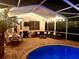 Night view of patio with fire pit, seating, and pool at 15927 Ternglade Dr, Lithia, FL 33547