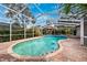 Relaxing kidney-shaped pool with brick pavers and screened enclosure at 15927 Ternglade Dr, Lithia, FL 33547