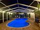 Lighted pool and patio at night, creating a relaxing ambiance at 15927 Ternglade Dr, Lithia, FL 33547