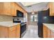 Bright kitchen features wood cabinets, black appliances, and tile flooring at 1601 43Rd N St # 133, St Petersburg, FL 33713