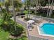 Community pool with brick patio and surrounding foliage at 1601 43Rd N St # 133, St Petersburg, FL 33713