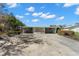 Mid-century modern home with carport and lush landscaping at 17020 Dolphin Dr, North Redington Beach, FL 33708