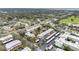 Aerial view of condo community with pond and parking at 1750 Belleair Forest Dr # A15, Belleair, FL 33756