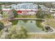 Aerial view of a pond and surrounding condo building at 1750 Belleair Forest Dr # A15, Belleair, FL 33756