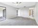 Large bedroom with ceiling fan and access to a private balcony at 1750 Belleair Forest Dr # A15, Belleair, FL 33756