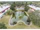 Aerial view of community pool and pond at 1750 Belleair Forest Dr # A15, Belleair, FL 33756