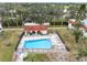 Community pool with surrounding lounge chairs at 1750 Belleair Forest Dr # A15, Belleair, FL 33756