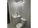 Bathroom with new toilet, new vanity, framed mirror, and modern lighting at 1804 Cadillac Cir, Tampa, FL 33619