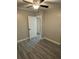 A bedroom with ceiling fan, light neutral walls, gray flooring, and a view of a doorway at 1804 Cadillac Cir, Tampa, FL 33619