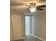 Bright bedroom featuring a new ceiling fan, gray wood-look flooring and a large closet for ample storage at 1804 Cadillac Cir, Tampa, FL 33619