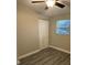 A bedroom with closet, gray flooring, light walls, small window with blinds and white trim at 1804 Cadillac Cir, Tampa, FL 33619