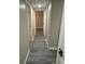 Hallway features grey vinyl flooring with doors on either side at 1804 Cadillac Cir, Tampa, FL 33619