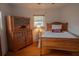 Cozy bedroom with hardwood floors and antique wooden furniture at 1900 41St N St, St Petersburg, FL 33713