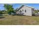 Backyard view with a large grassy area and playground at 2070 28Th St, Sarasota, FL 34234