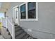 Exterior entrance to the home featuring steps up to the front door and windows with dark frames at 2070 28Th St, Sarasota, FL 34234