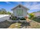 Home exterior with attractive landscaping, decorative water feature, and a freshly painted façade at 2070 28Th St, Sarasota, FL 34234