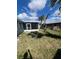 Spacious backyard showing screened in porch and palm trees at 22065 Malone Ave, Port Charlotte, FL 33952