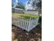 Fenced backyard featuring green grass and white picket fence at 22065 Malone Ave, Port Charlotte, FL 33952