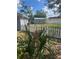 Backyard featuring a white picket fence and a small shed in the distance at 22065 Malone Ave, Port Charlotte, FL 33952