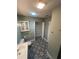 Bathroom featuring decorative flooring, updated vanity, and a storage closet at 22065 Malone Ave, Port Charlotte, FL 33952