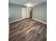 Bedroom featuring updated wood-look floors, neutral paint and a ceiling fan at 22065 Malone Ave, Port Charlotte, FL 33952