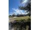 This exterior shot shows the house and yard, showcasing its well-kept lawn and inviting curb appeal at 22065 Malone Ave, Port Charlotte, FL 33952