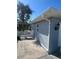 A brick painted exterior wall featuring a white picket fence, showcasing the home's charm and character at 22065 Malone Ave, Port Charlotte, FL 33952