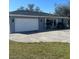 The exterior features a freshly painted attached garage and neat landscaping at 22065 Malone Ave, Port Charlotte, FL 33952