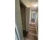 Hallway featuring wood-look flooring and a storage closet with shelves at 22065 Malone Ave, Port Charlotte, FL 33952