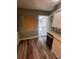 View of kitchen with wood laminate flooring leading to the door to the screened-in porch at 22065 Malone Ave, Port Charlotte, FL 33952