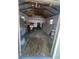 View of the shed interior with plywood flooring and exposed rafters at 22065 Malone Ave, Port Charlotte, FL 33952