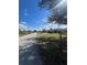 A street view of a single story home with well-maintained landscaping and a circular driveway at 22065 Malone Ave, Port Charlotte, FL 33952