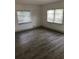 Spacious living area with gray vinyl plank flooring and window blinds at 2421 19Th S St, St Petersburg, FL 33712