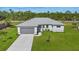 Aerial view of a single-story house with a gray roof and driveway at 25434 Alicante Dr, Punta Gorda, FL 33955