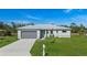 Aerial view of a single-story house with gray garage doors and a mailbox at 25434 Alicante Dr, Punta Gorda, FL 33955