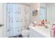 Bathroom with white shower curtain with dog illustrations, white vanity and wall cabinet at 2648 Sabal Springs Dr # 2, Clearwater, FL 33761