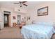 Bright bedroom with a ceiling fan, coastal decor, and adjacent bathroom entrance at 2648 Sabal Springs Dr # 2, Clearwater, FL 33761