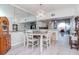 Dining area featuring modern light fixture and view to the kitchen and water at 2648 Sabal Springs Dr # 2, Clearwater, FL 33761